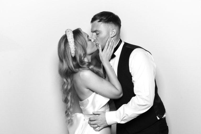 Black and White Photo Booth showing bride and groom kissing on their wedding day