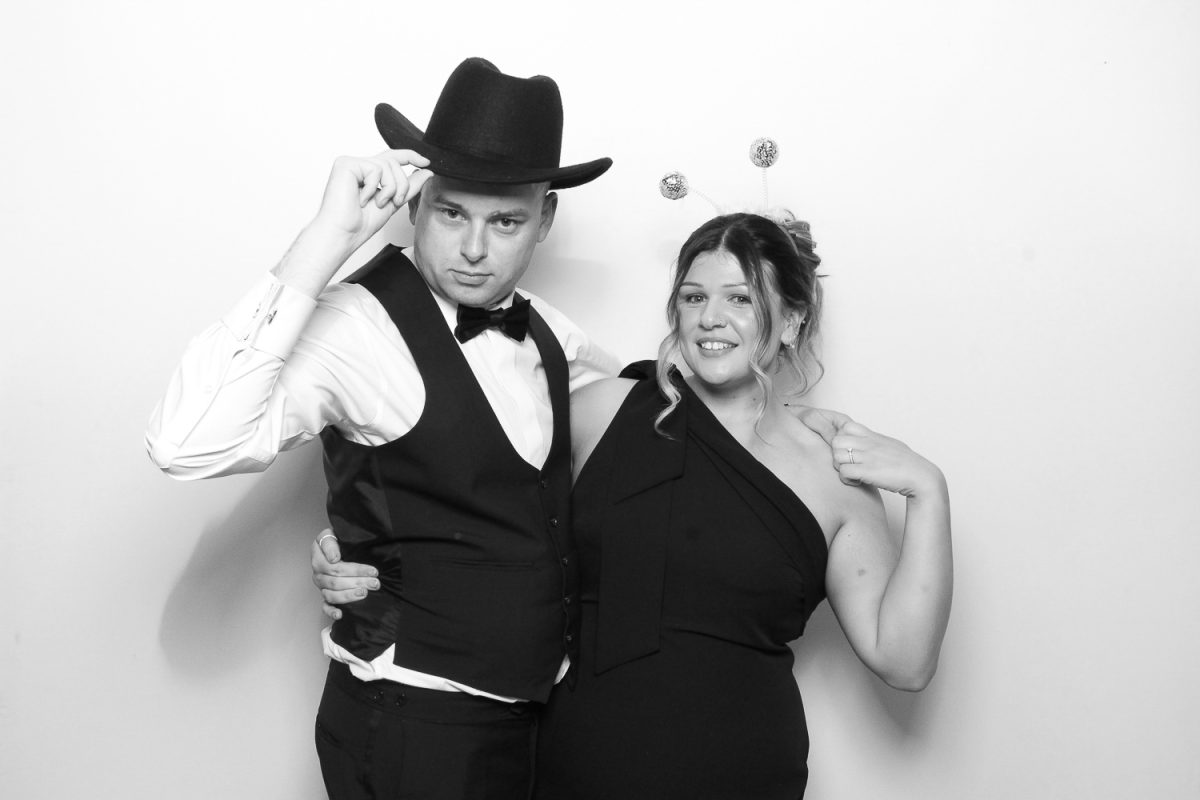 Couple posing in Photo Booth with props at Middleton Lodge Wedding