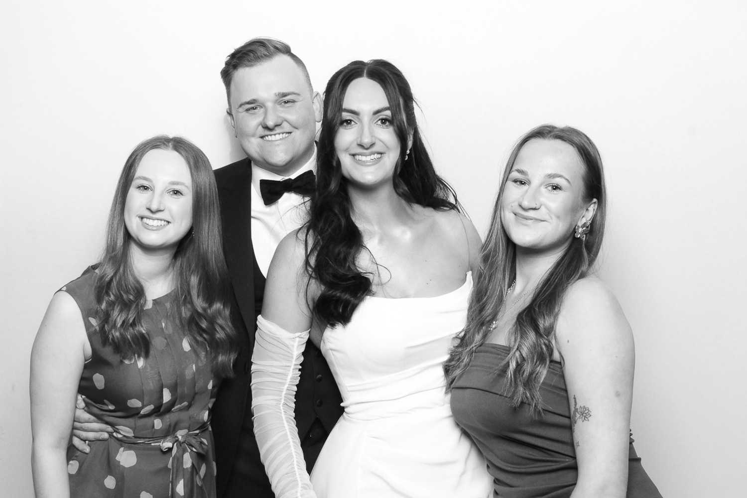 Bride and groom with guests in black and white Photo Booth at Middleton Lodge Wedding